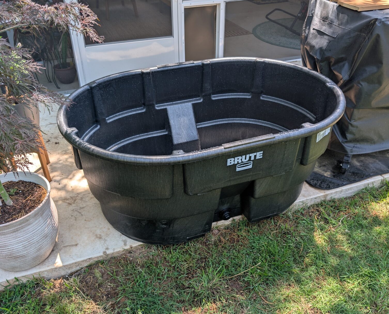 May 4. The first thing bought for the whole project: a 150 gallon Rubbermaid stock tank to hold livestock during the move.